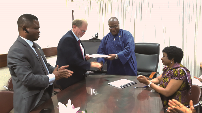 The Minister of Health, Mr Alex Segbefia (2nd from right), exchanging the MoU with Mr David Carmdy, the Project Facilitator of Synergy Group. With them is Reverend Joseph Kwesi Avemegah, a local representative of Synergy Group in Ghana